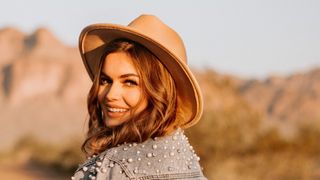 image of Zuzanna Blasco headshot - white woman with blonde hair and a cowboy hat