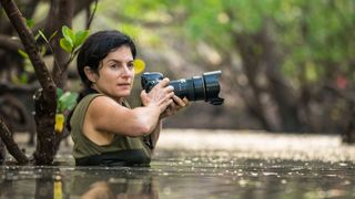 image of a woman in some water with a camera