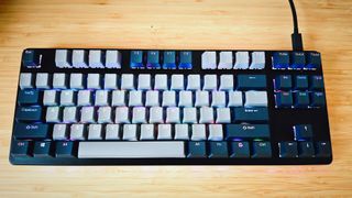 A black Drop CTRL V2 keyboard on a wooden desk